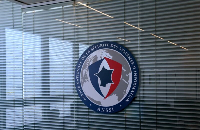 An agency logo hangs on an interior office window.