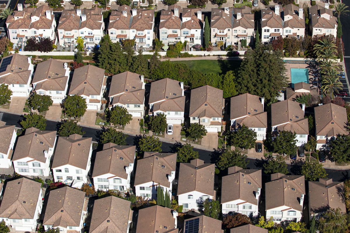 Tightly packed rows of mostly identical houses, seen from above.