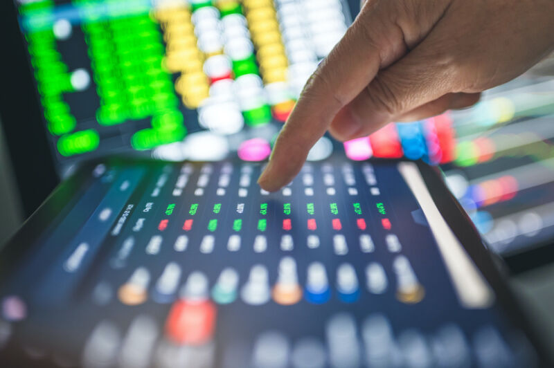 Close-up photo of hand operating touchscreen.