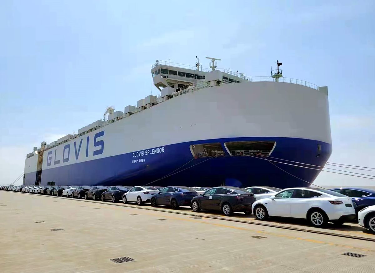 A ship is loaded with electric cars produced by U.S. automaker Tesla’s Shanghai Gigafactory at a port in east China’s Shanghai, May 11, 2022