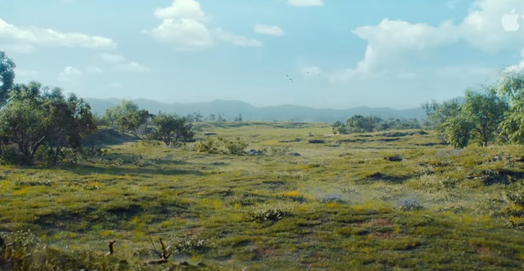 widescreen view of lush flat landscape against a a blue sky