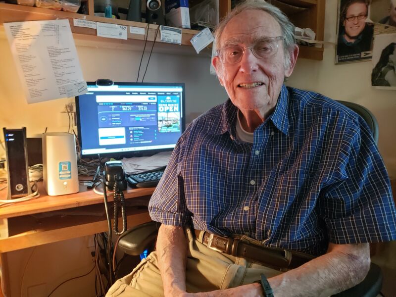 90-year-old Aaron Epstein sits in front of a computer screen showing speed-test results.
