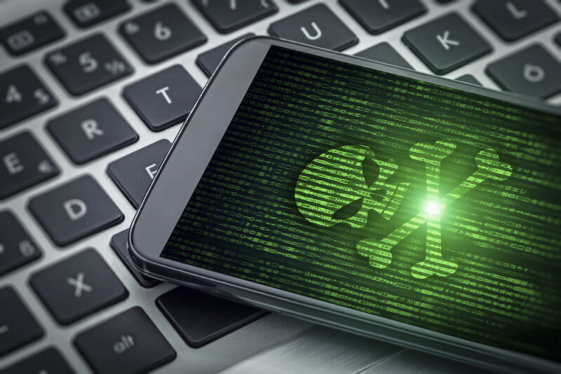 Stock photo of skull and crossbones on a smartphone screen.