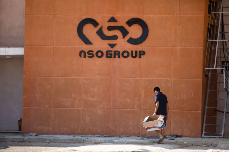 A man walks by the building entrance of Israeli cyber company NSO Group at one of its branches in the Arava Desert on November 11, 2021, in Sapir, Israel.
