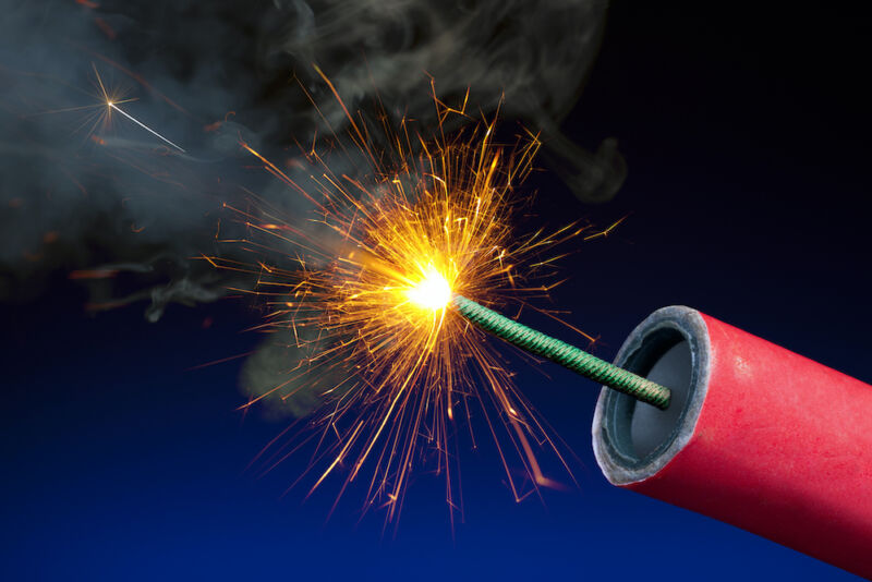 Stock photo of the lit fuse of a stick of dynamite or firework.