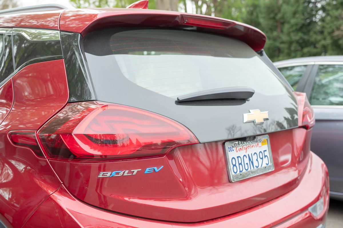 View from behind of red Chevrolet Bolt electric car, with logo visible, in Danville, California, March, 2020.