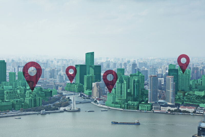 Map pin flat on green cityscape and Huangpu River