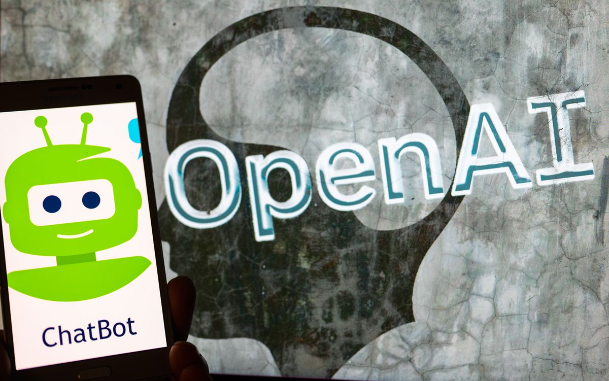 OpenAI logo seen on screen with ChatBot logo displayed on mobile seen in this illustration in Brussels, Belgium, on December 12, 2022